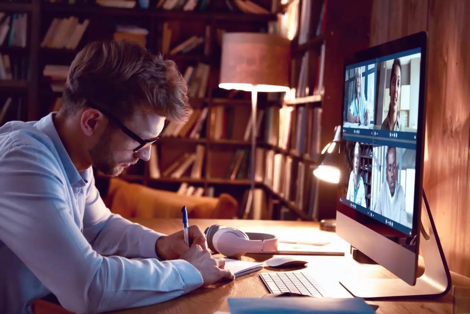 Student working on code optimization project with multiple monitors showing performance metrics